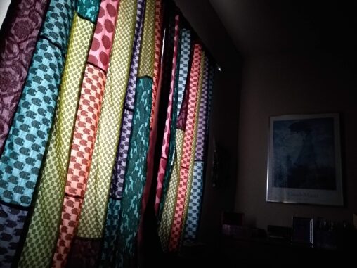 Morning light through quilt-like curtains.